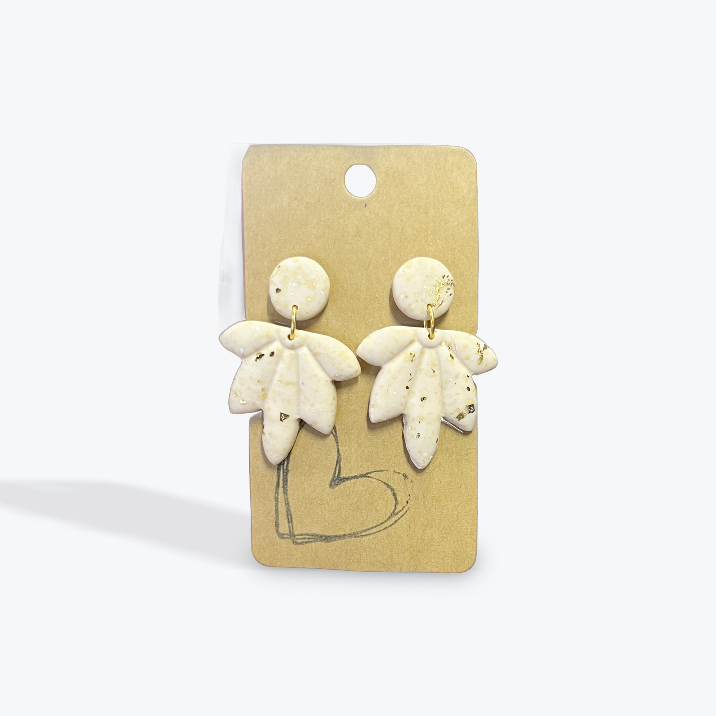 Handcrafted clay earrings with neutral patterns and artisan detail