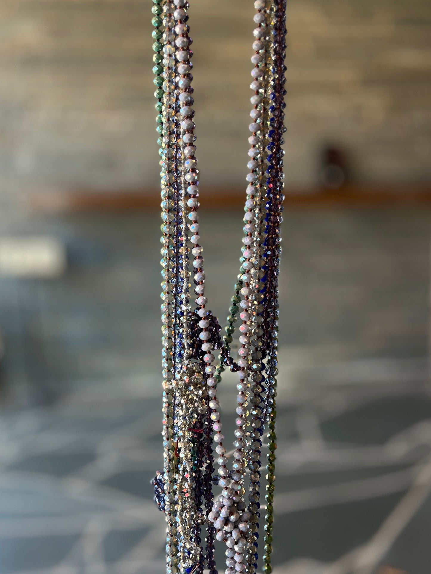 Long plastic beaded necklace in jewel tone purple