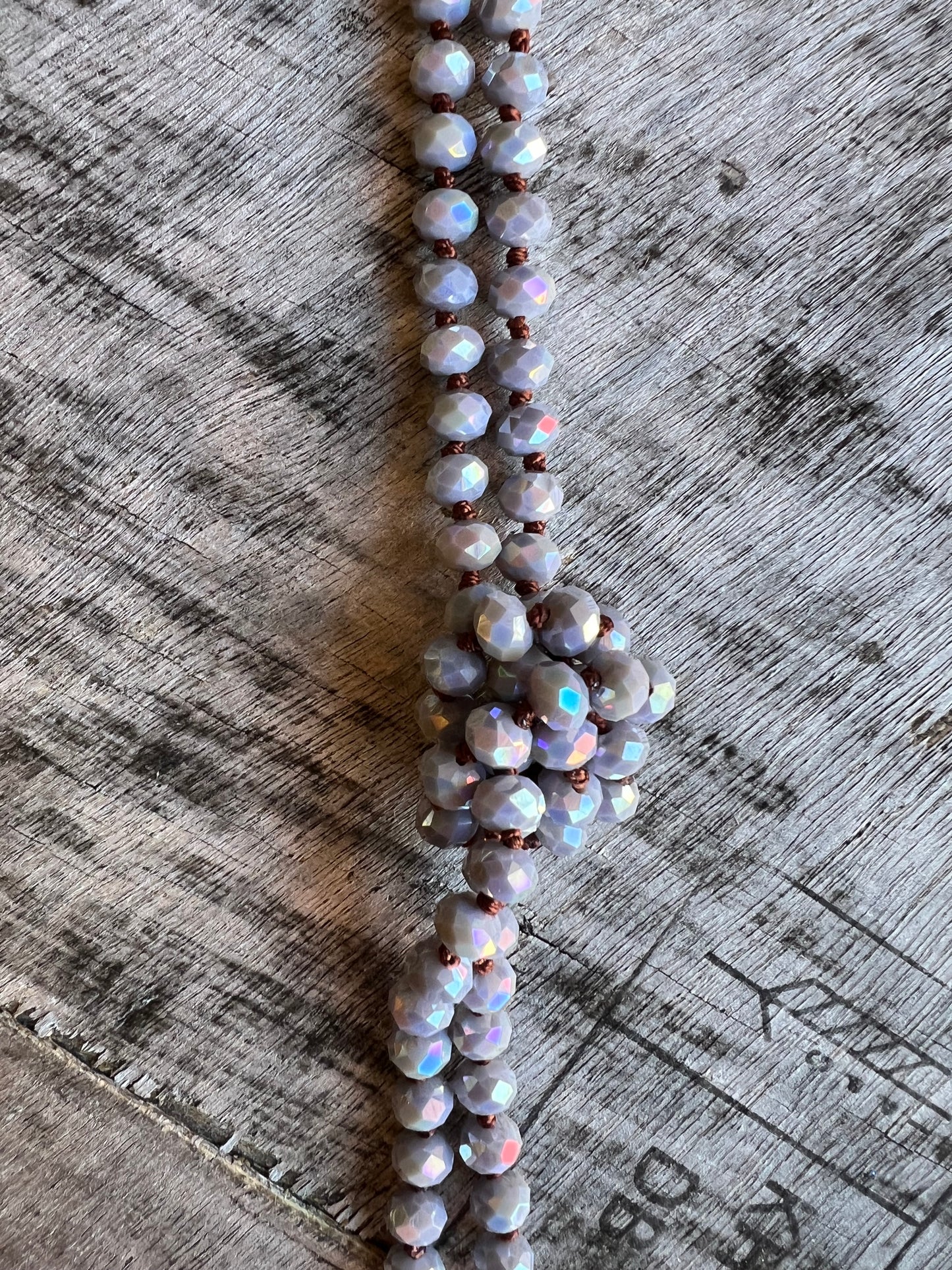 Blue beaded rope necklace styled for layering