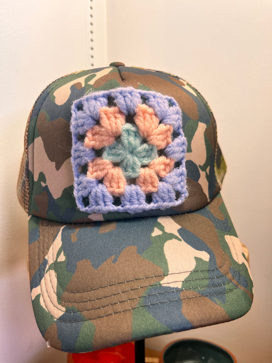 Handmade crochet ball cap featuring artisan granny square accent