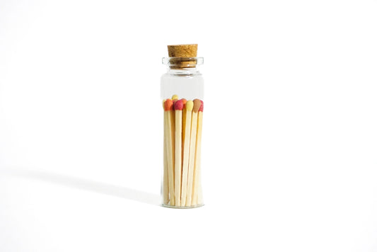 Decorative glass bottle filled with colorful vintage matches