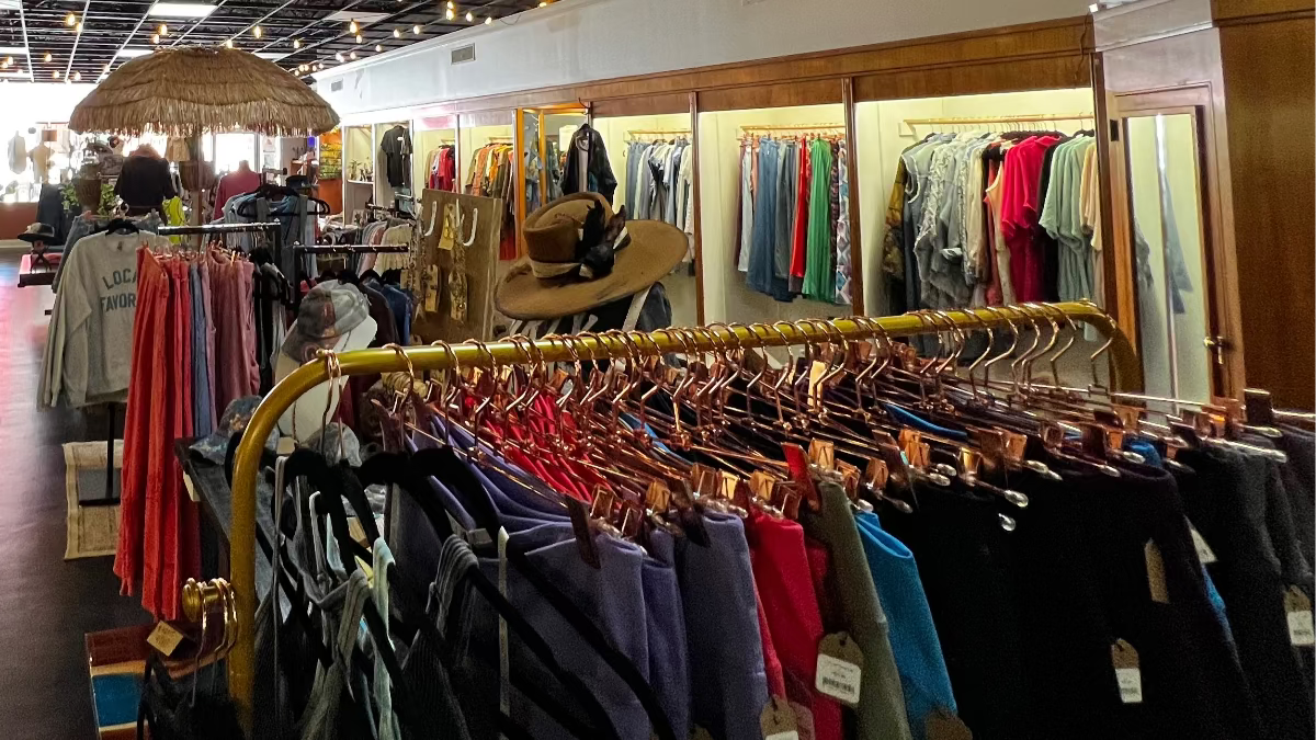Inside Emporium 23 boutique in Newton NC featuring women’s clothing racks, hats, and artisan fashion displays