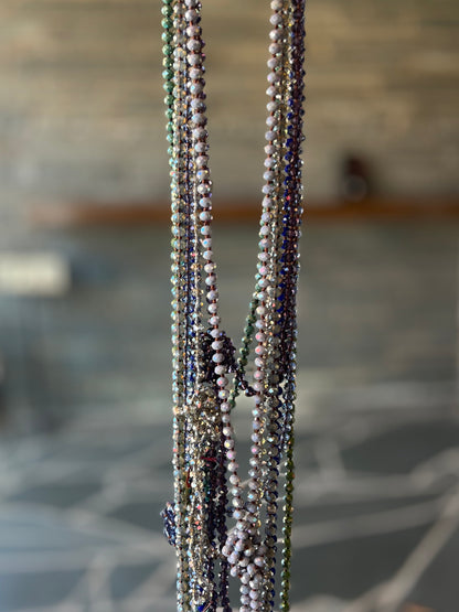 Long plastic beaded necklace in jewel tone purple
