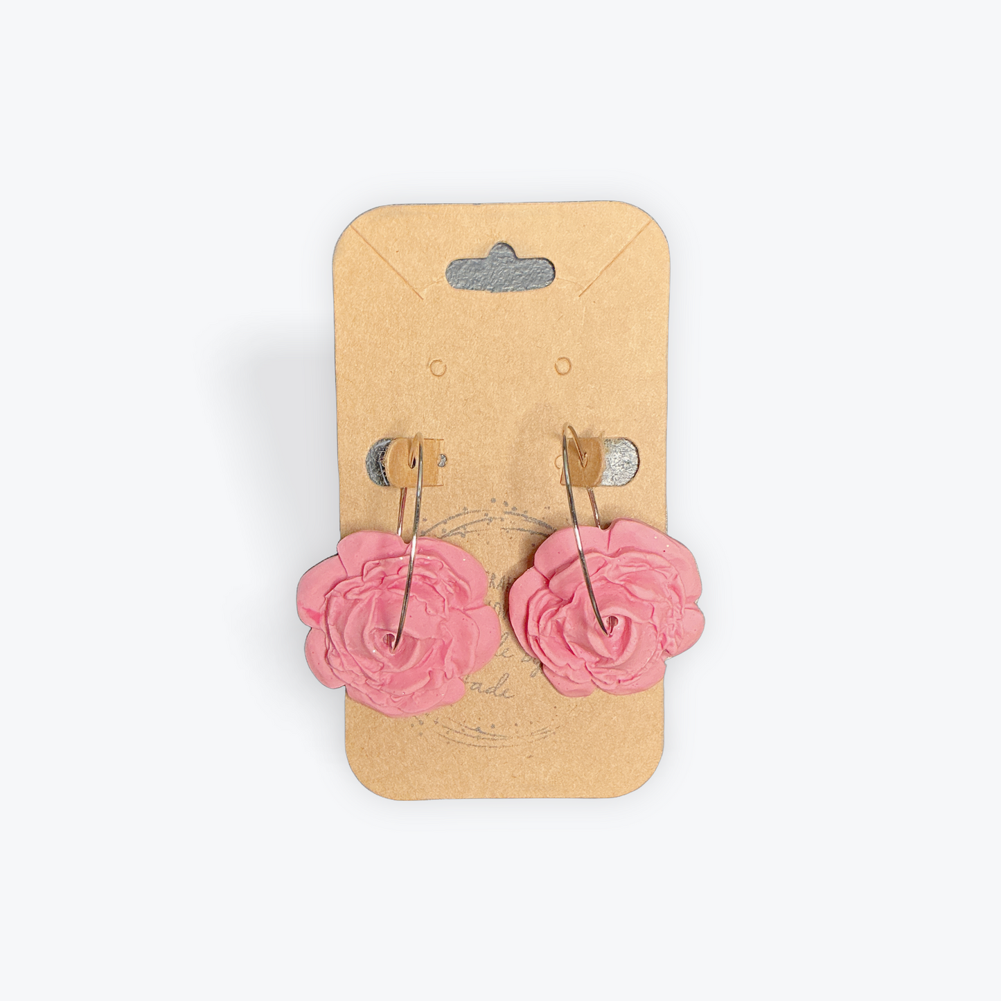 Handmade clay earrings with detailed artisan pattern