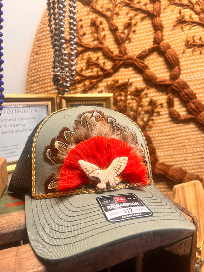 Boho style hat featuring feathers and artisan accents