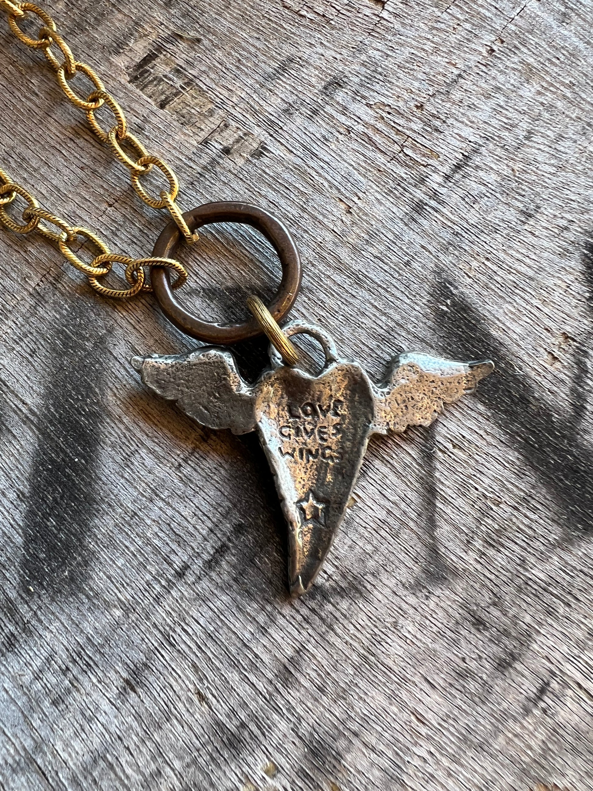 Layered gold necklaces with cross and charm details