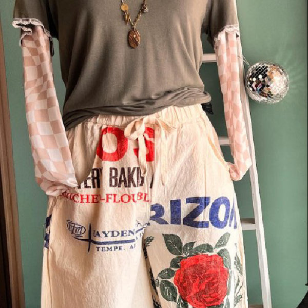 Upcycled boutique pants with bold graphic print and red rose design – unique artisan fashion from Emporium 23